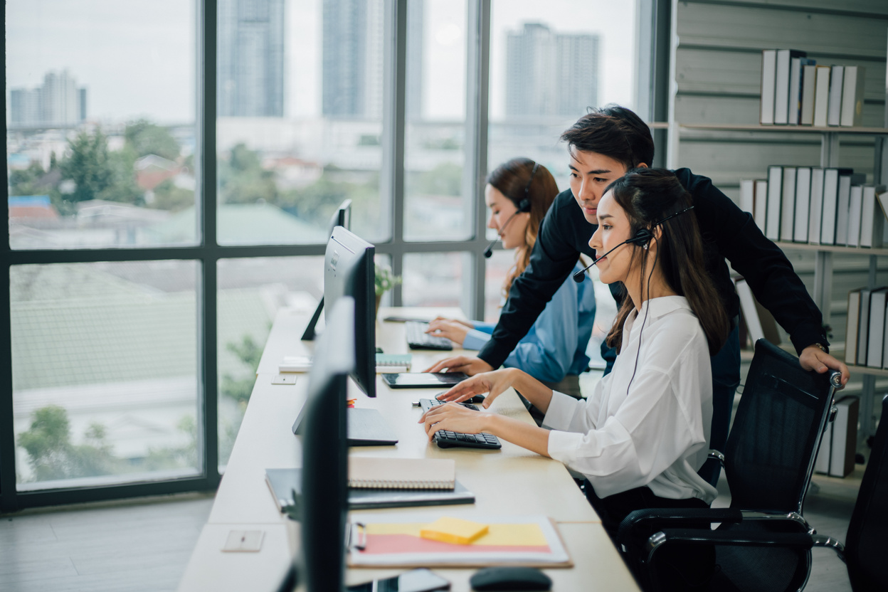 Male Agent Operator Assisting Colleague